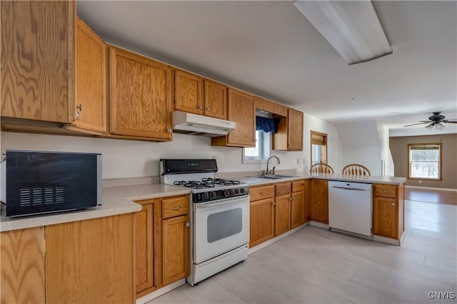 kitchen featuring ceiling fan, white appliances, sink, and kitchen peninsula