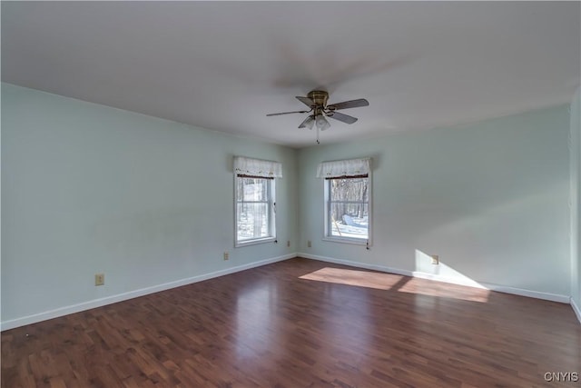 empty room featuring ceiling fan and dark hardwood / wood-style flooring