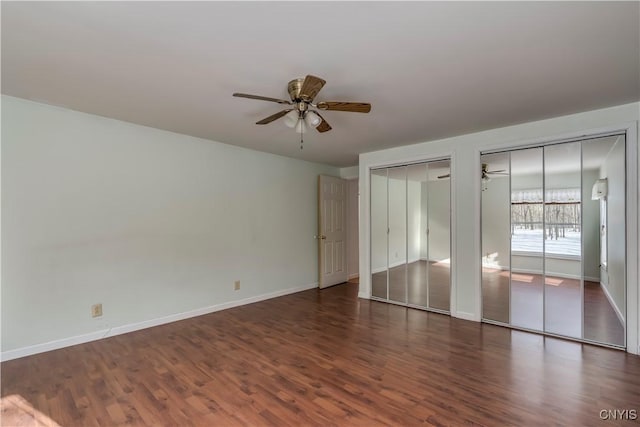 empty room with ceiling fan and dark wood-type flooring