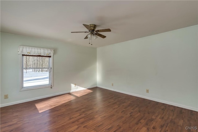 spare room featuring dark hardwood / wood-style floors and ceiling fan