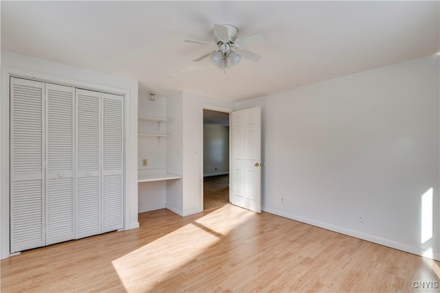 unfurnished bedroom with ceiling fan, a closet, and light hardwood / wood-style flooring