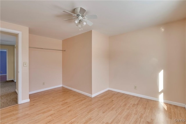 spare room with ceiling fan and light wood-type flooring