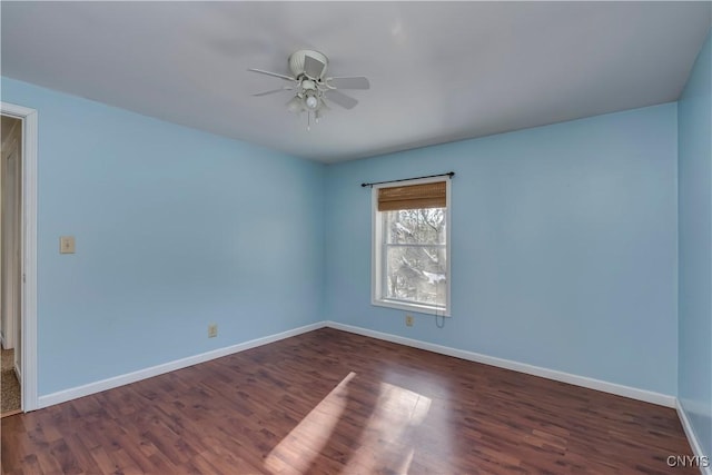 unfurnished room with ceiling fan and dark wood-type flooring