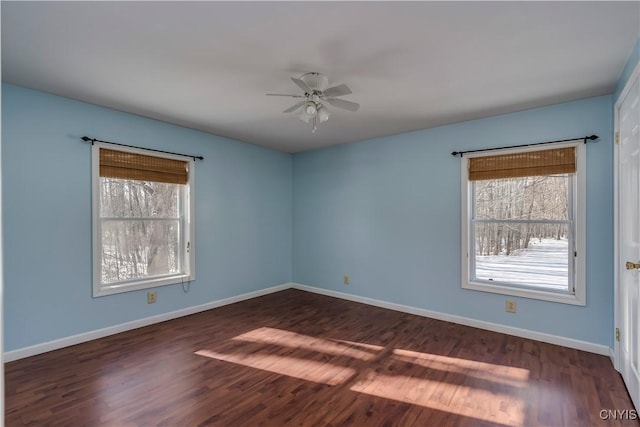 spare room with dark hardwood / wood-style floors and ceiling fan