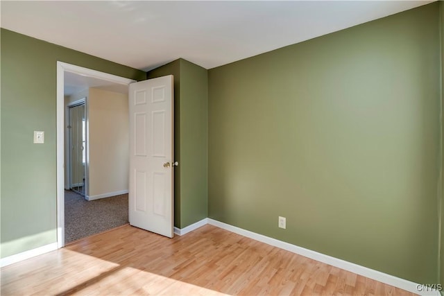 empty room with hardwood / wood-style floors