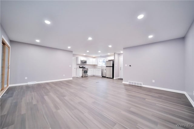 unfurnished living room with light wood-type flooring