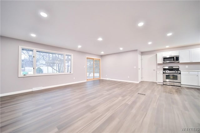 unfurnished living room featuring light wood-type flooring