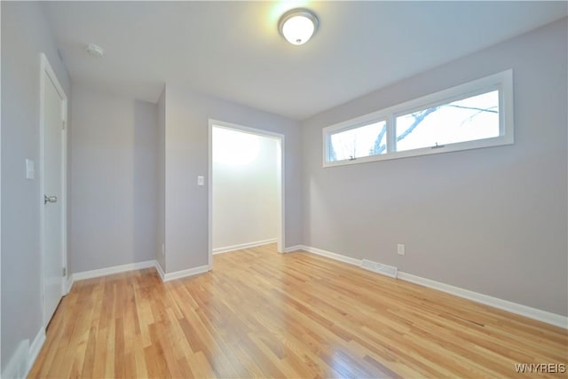 unfurnished room with light wood-type flooring