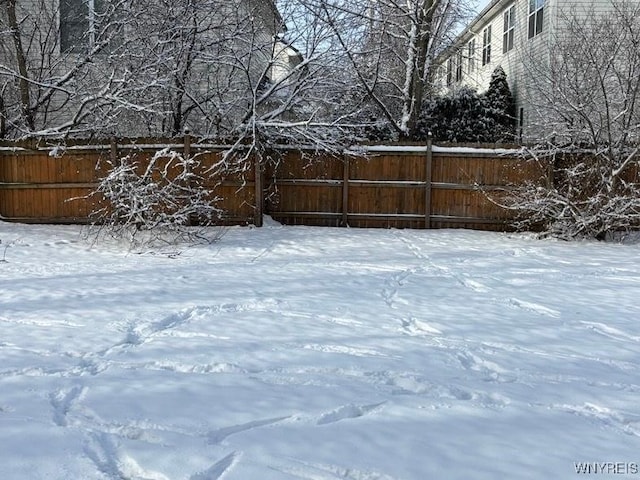 view of yard layered in snow