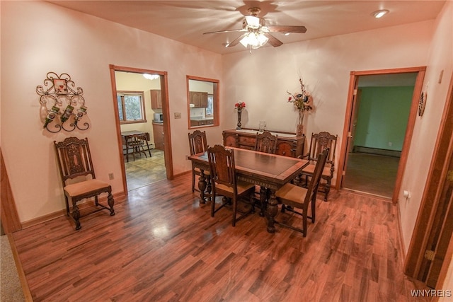 dining area with ceiling fan, baseboard heating, and dark hardwood / wood-style floors