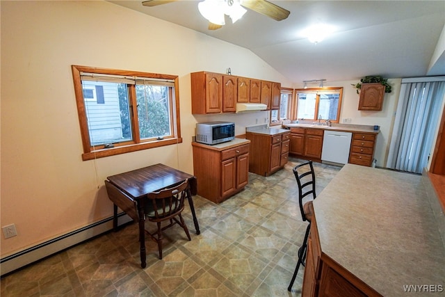 kitchen featuring vaulted ceiling, baseboard heating, white dishwasher, and a healthy amount of sunlight