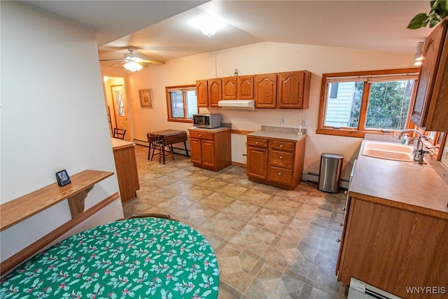 kitchen featuring ceiling fan, sink, baseboard heating, and lofted ceiling