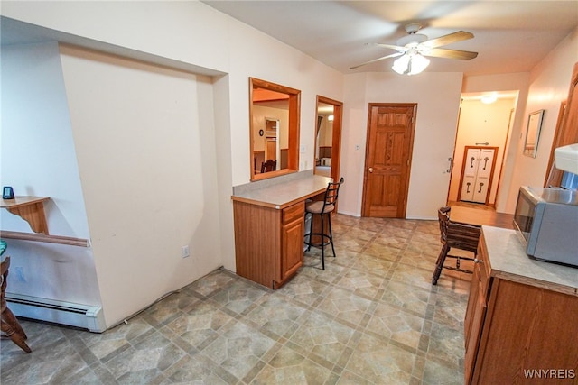 kitchen with ceiling fan and a baseboard radiator