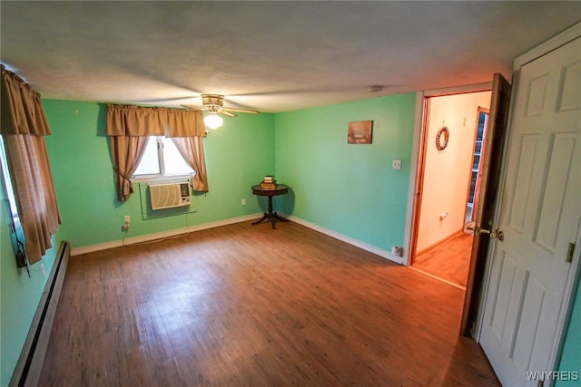 empty room featuring ceiling fan, a baseboard heating unit, dark hardwood / wood-style flooring, and a wall unit AC