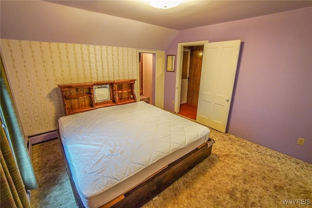 bedroom with vaulted ceiling and dark carpet