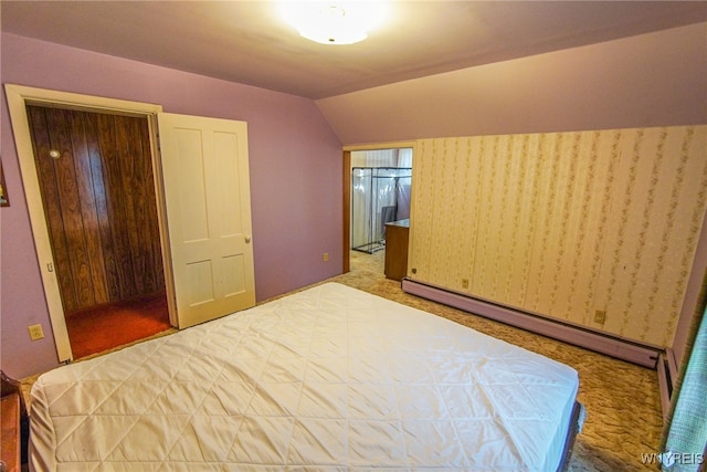 bedroom featuring carpet, a baseboard heating unit, and vaulted ceiling