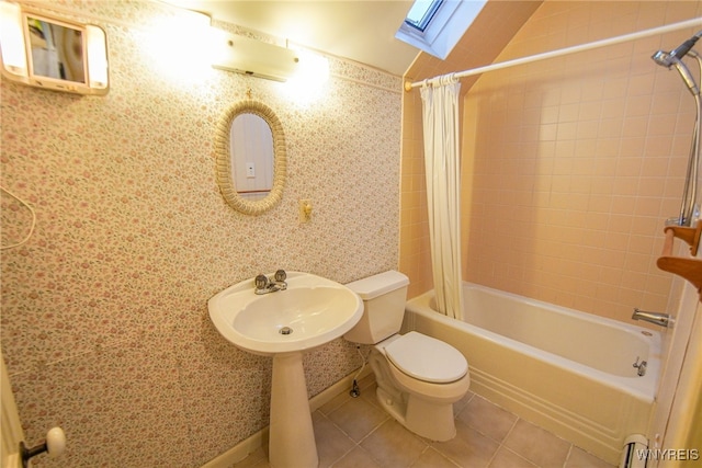 full bathroom with toilet, tile patterned flooring, vaulted ceiling with skylight, shower / bath combo, and baseboard heating