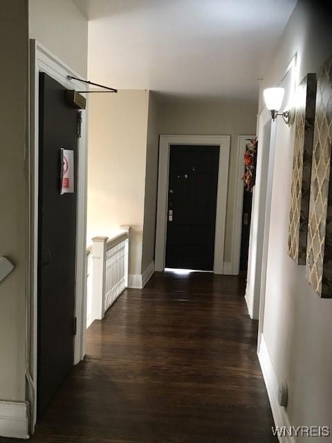 hallway featuring dark wood-type flooring