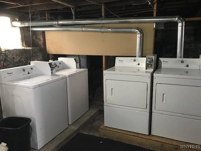 clothes washing area featuring separate washer and dryer