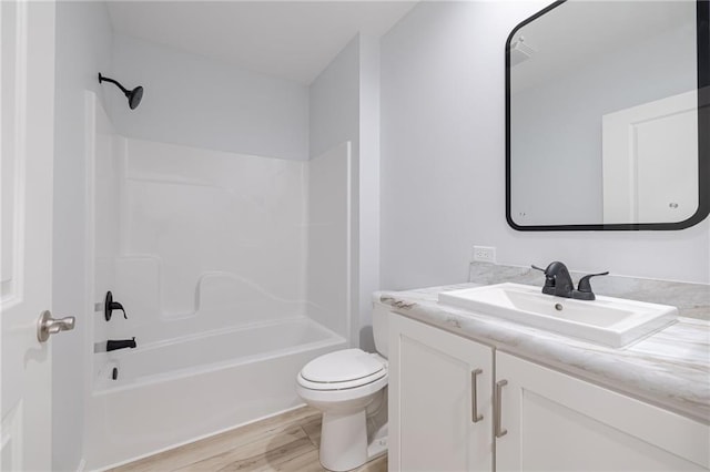 full bathroom with hardwood / wood-style floors, vanity, toilet, and tub / shower combination