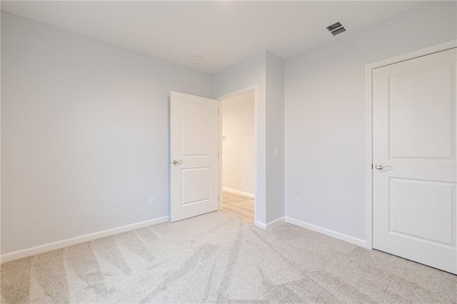 empty room featuring light colored carpet