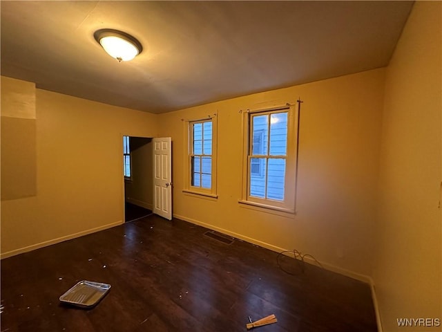 empty room with dark hardwood / wood-style floors