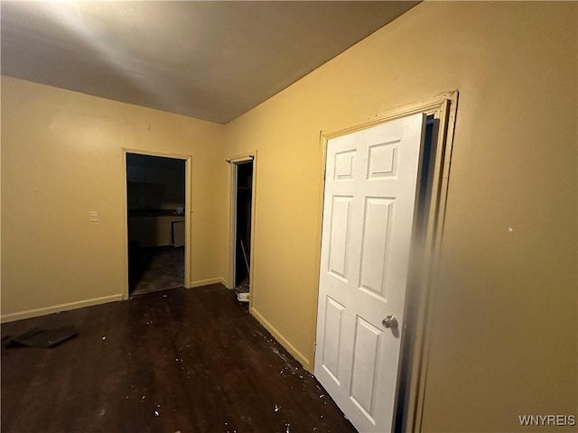 corridor with dark wood-type flooring