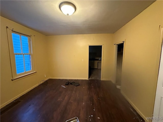 unfurnished room featuring dark wood-type flooring