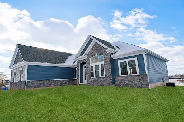 view of front of home with central AC unit and a front lawn