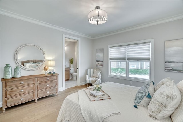 bedroom featuring crown molding, connected bathroom, and light wood-type flooring