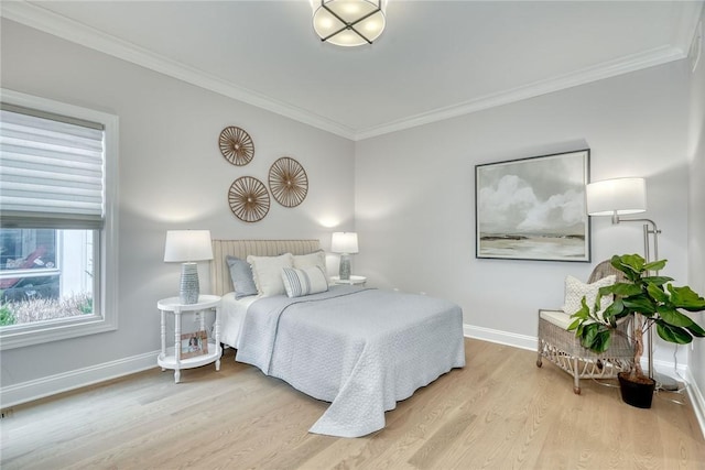 bedroom featuring crown molding and light hardwood / wood-style floors