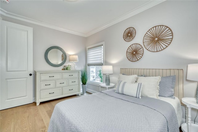 bedroom with crown molding and light wood-type flooring