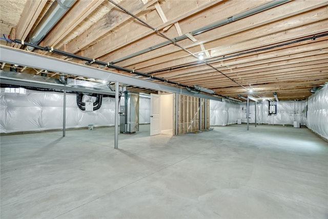 basement with heating unit and electric panel