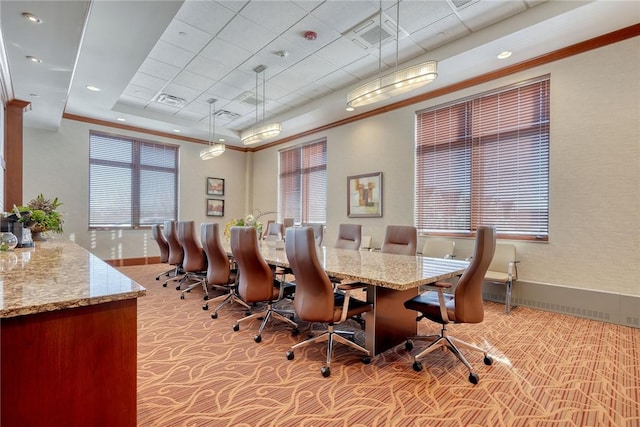 carpeted home office with ornamental molding and a tray ceiling