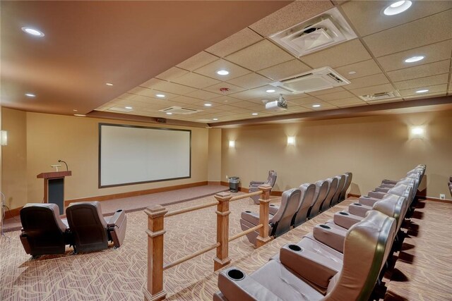 cinema room with carpet flooring and a drop ceiling