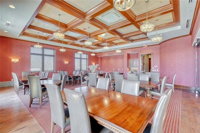 dining space with coffered ceiling, beam ceiling, light hardwood / wood-style flooring, and ornamental molding