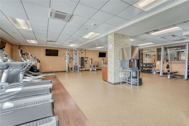 workout area with hardwood / wood-style floors and a paneled ceiling