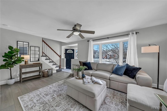 living room with ceiling fan and light wood-type flooring