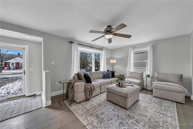 living room with hardwood / wood-style floors and ceiling fan