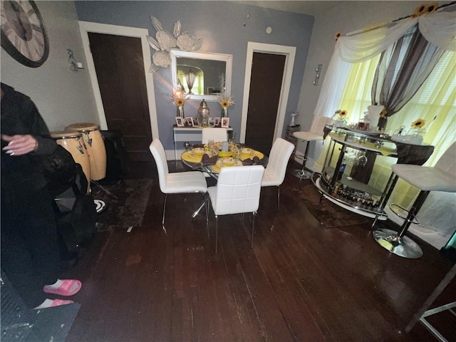 dining area with dark hardwood / wood-style flooring