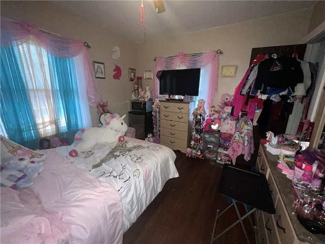 bedroom with dark hardwood / wood-style floors and ceiling fan