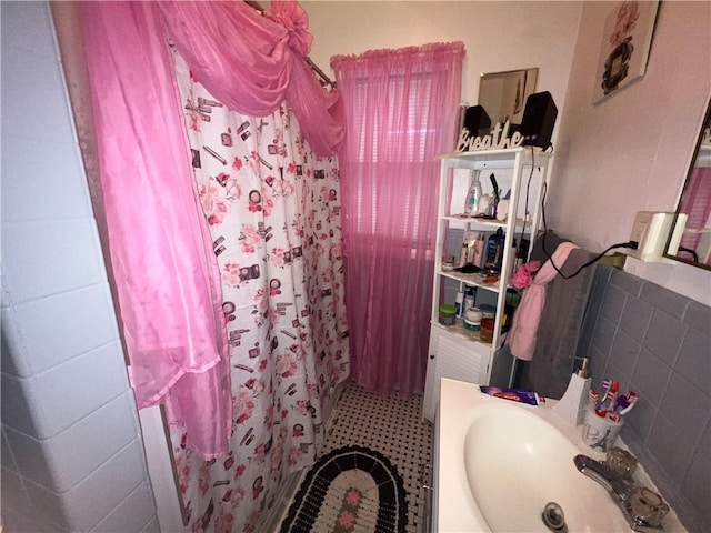 bathroom featuring vanity and a shower with shower curtain