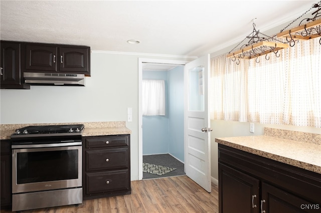 kitchen with light hardwood / wood-style floors, dark brown cabinetry, electric stove, and crown molding