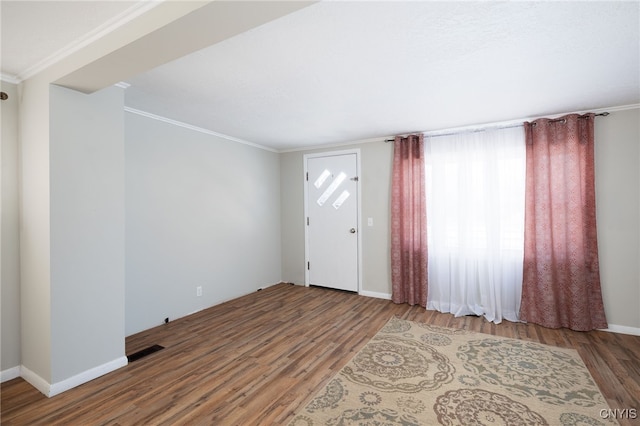 entrance foyer featuring hardwood / wood-style floors and ornamental molding