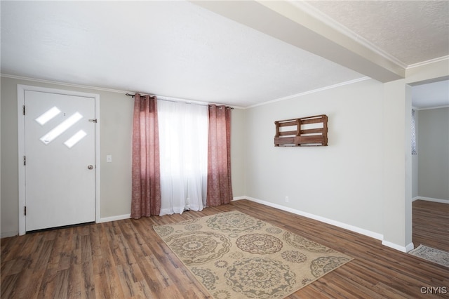 entrance foyer featuring a textured ceiling, dark hardwood / wood-style flooring, and crown molding