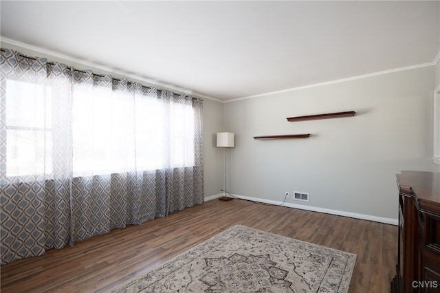 spare room with dark hardwood / wood-style floors and ornamental molding