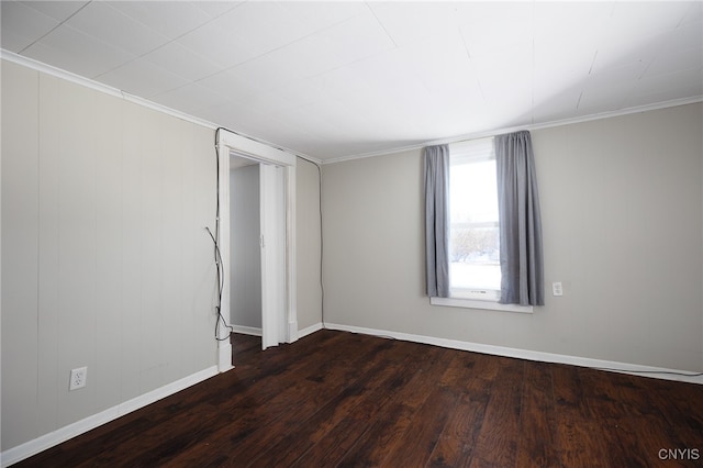 empty room with crown molding and dark wood-type flooring