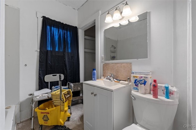 bathroom with backsplash, vanity, and toilet