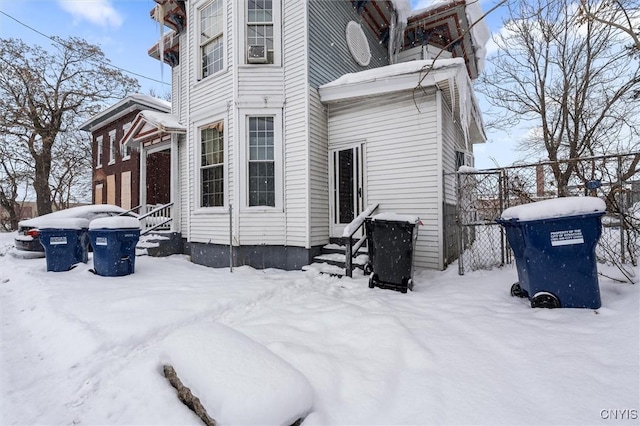 view of snow covered rear of property