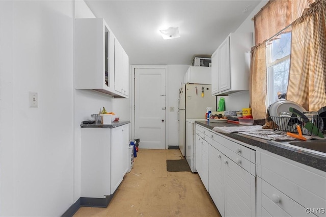 kitchen with white cabinets and white refrigerator